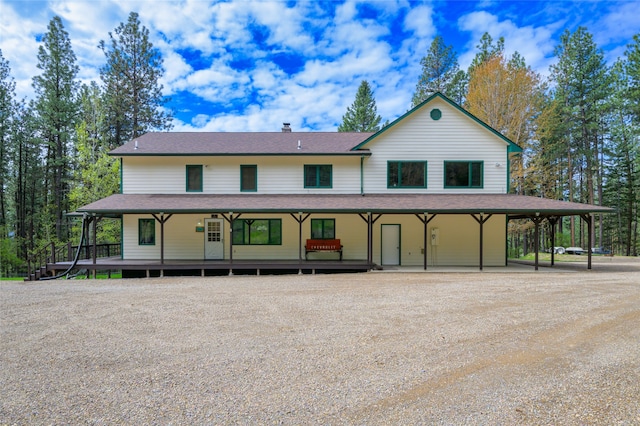 farmhouse-style home with a carport