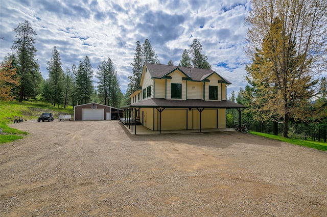 country-style home featuring an outdoor structure and a garage