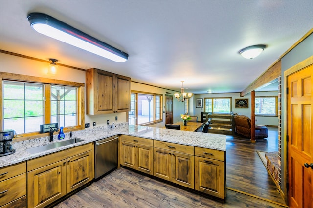 kitchen featuring dark hardwood / wood-style floors, a healthy amount of sunlight, and dishwasher