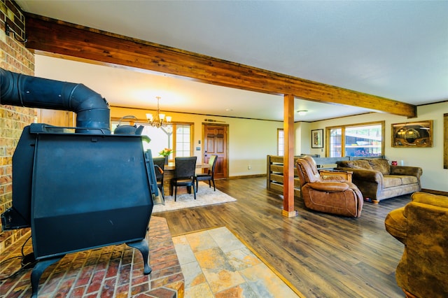 living room featuring beamed ceiling, a notable chandelier, a wealth of natural light, and dark hardwood / wood-style flooring