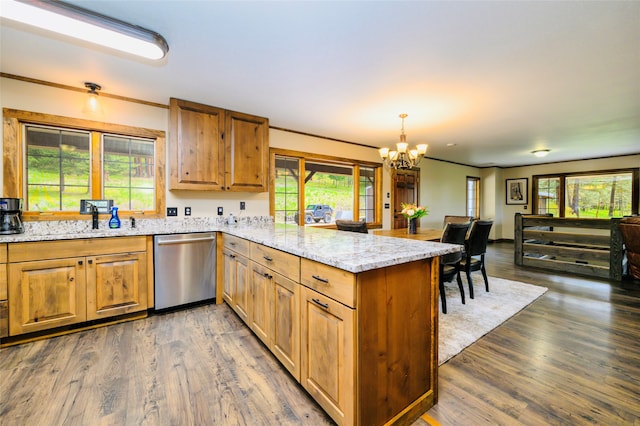 kitchen with dishwasher, wood-type flooring, and a wealth of natural light