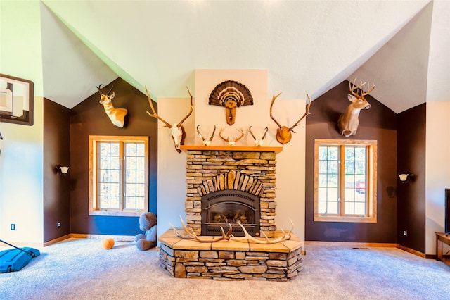 living room featuring plenty of natural light, a fireplace, and carpet floors