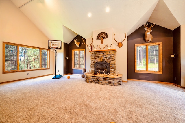 unfurnished living room with a stone fireplace, carpet flooring, and vaulted ceiling