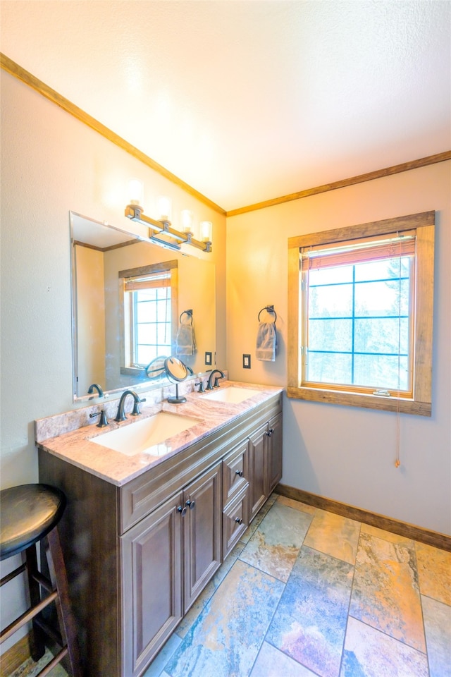 bathroom featuring oversized vanity, double sink, tile floors, and crown molding