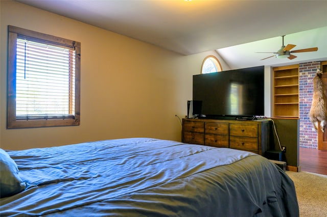 bedroom featuring brick wall, carpet, ceiling fan, and lofted ceiling