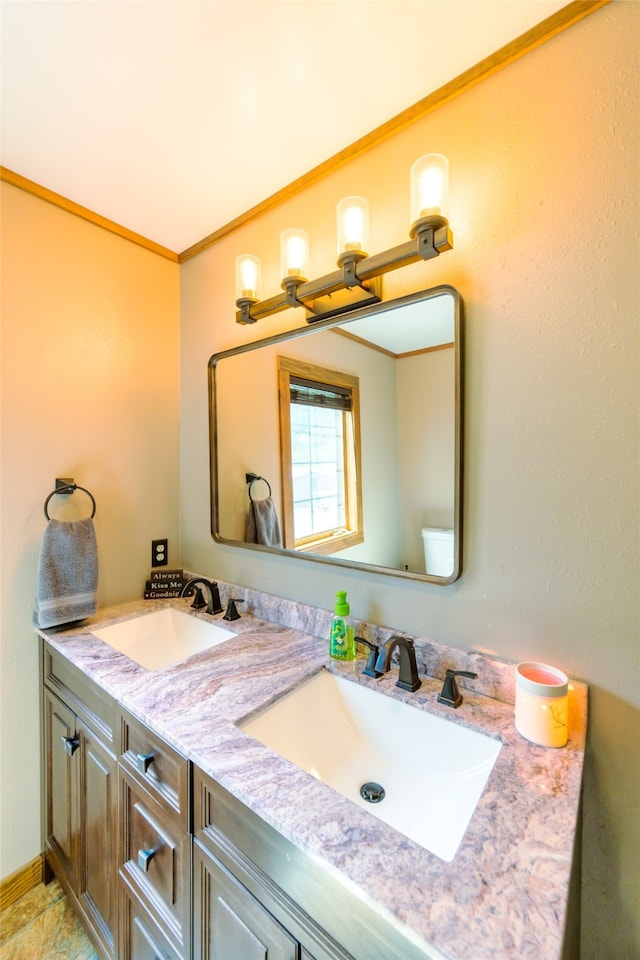 bathroom featuring tile floors, ornamental molding, oversized vanity, and dual sinks