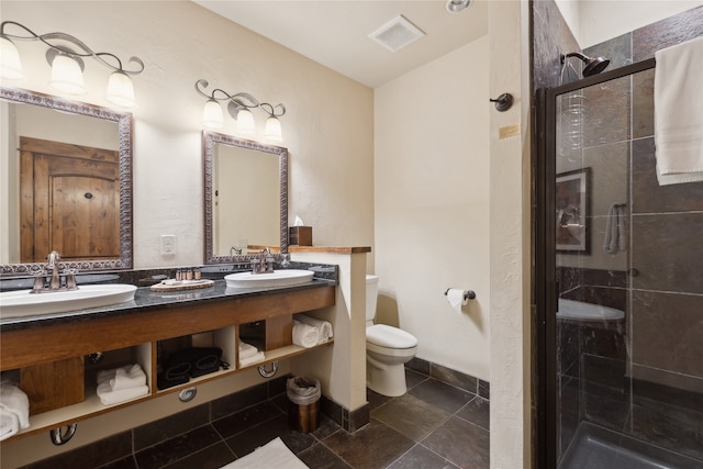 bathroom with tile floors, walk in shower, toilet, and double sink vanity