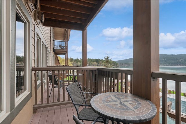 wooden terrace featuring a water view