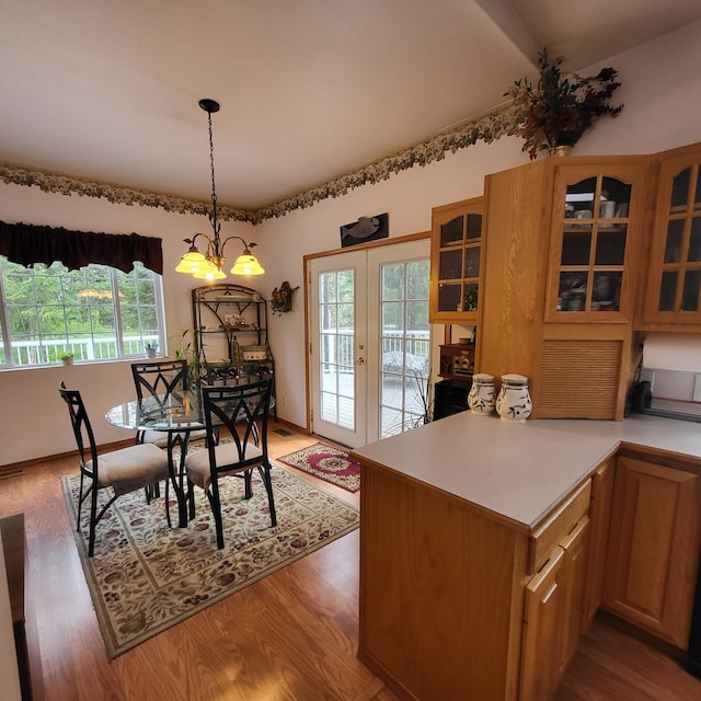 dining space featuring an inviting chandelier, light wood-type flooring, and french doors