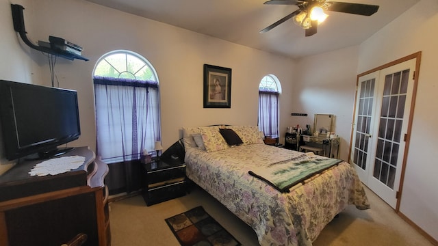 carpeted bedroom featuring french doors and ceiling fan