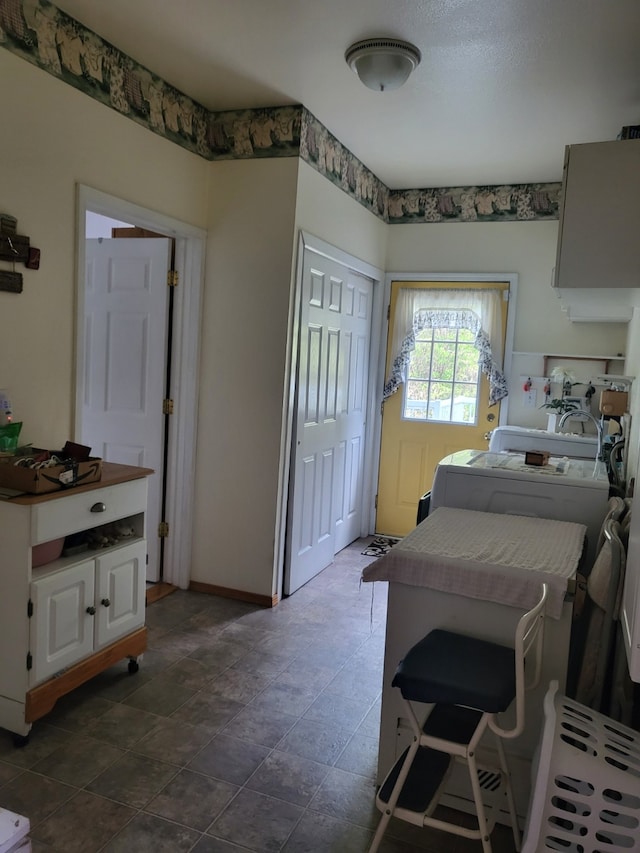 tiled bedroom with washer / clothes dryer and a closet