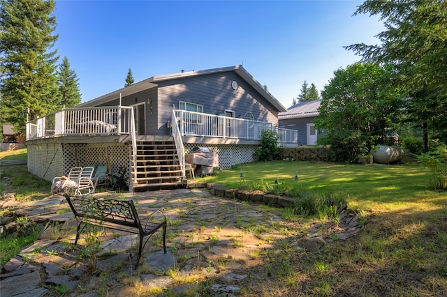 rear view of property with a yard and a wooden deck