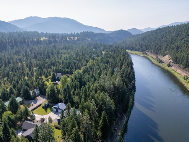 birds eye view of property with a water and mountain view