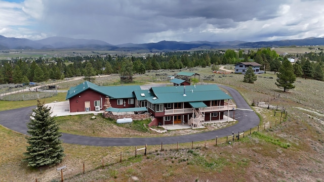 drone / aerial view with a mountain view and a rural view