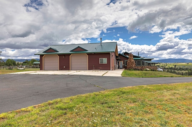 view of front of house featuring a garage and a front lawn