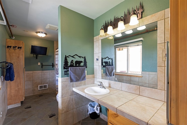 bathroom featuring tile flooring, tile walls, a shower, vanity with extensive cabinet space, and toilet