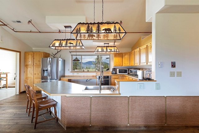 5282 Otto Way, Florence, MT 59833 - kitchen with white microwave, a peninsula, dark wood finished floors, stainless steel refrigerator with ice dispenser, and hanging light fixtures