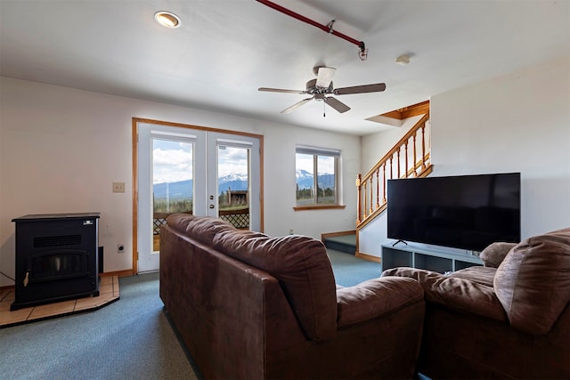 living room featuring a mountain view, ceiling fan, french doors, and carpet flooring