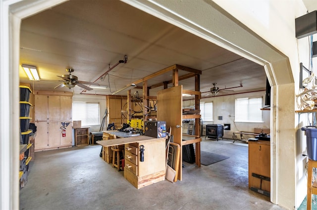 interior space featuring ceiling fan and a workshop area