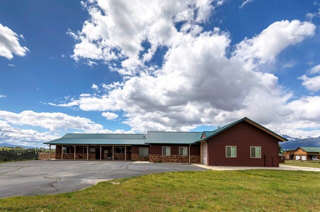 5282 Otto Way, Florence, MT 59833 - view of front of home featuring a front lawn, a metal roof, and stone siding