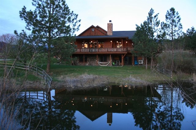 856 Weber Butte Trl, Corvallis, MT 59828 - rear view of property with a chimney, a lawn, and a deck with water view