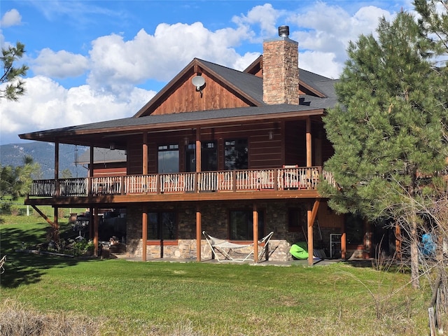 856 Weber Butte Trl, Corvallis, MT 59828 - rear view of house with a lawn, a chimney, a deck, and stone siding