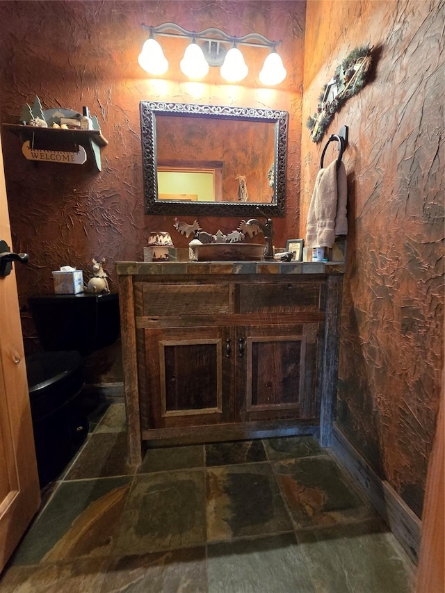 856 Weber Butte Trl, Corvallis, MT 59828 - bathroom featuring vanity and stone finish floors