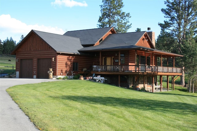 856 Weber Butte Trl, Corvallis, MT 59828 - log cabin featuring a chimney, a front yard, a garage, a wooden deck, and asphalt driveway