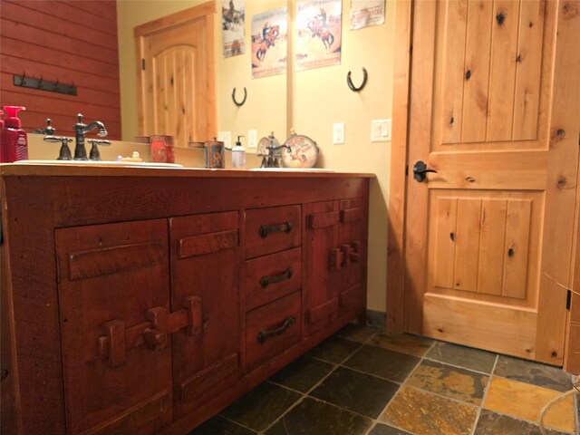 856 Weber Butte Trl, Corvallis, MT 59828 - bathroom with stone tile flooring, vanity, and wooden walls