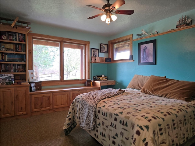 856 Weber Butte Trl, Corvallis, MT 59828 - bedroom featuring a textured ceiling, carpet floors, and a ceiling fan
