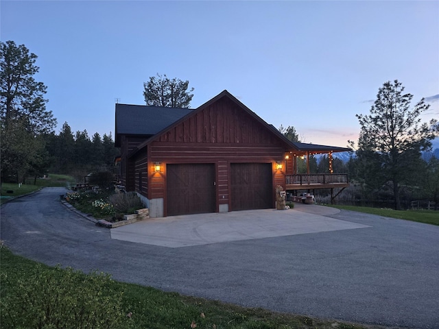 856 Weber Butte Trl, Corvallis, MT 59828 - property exterior at dusk featuring driveway, a garage, and board and batten siding