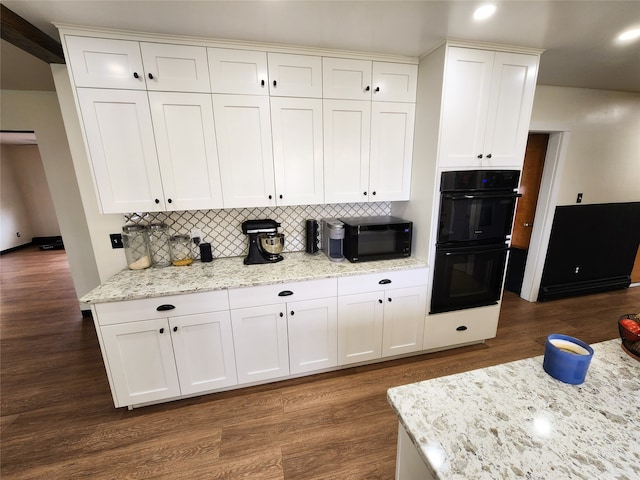 kitchen with light stone counters, backsplash, dark hardwood / wood-style flooring, and black appliances