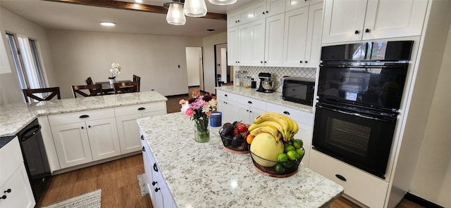 kitchen featuring black appliances, white cabinetry, and a kitchen island