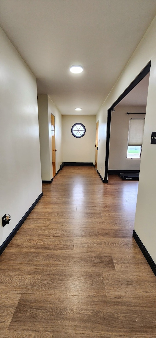 corridor with wood-type flooring