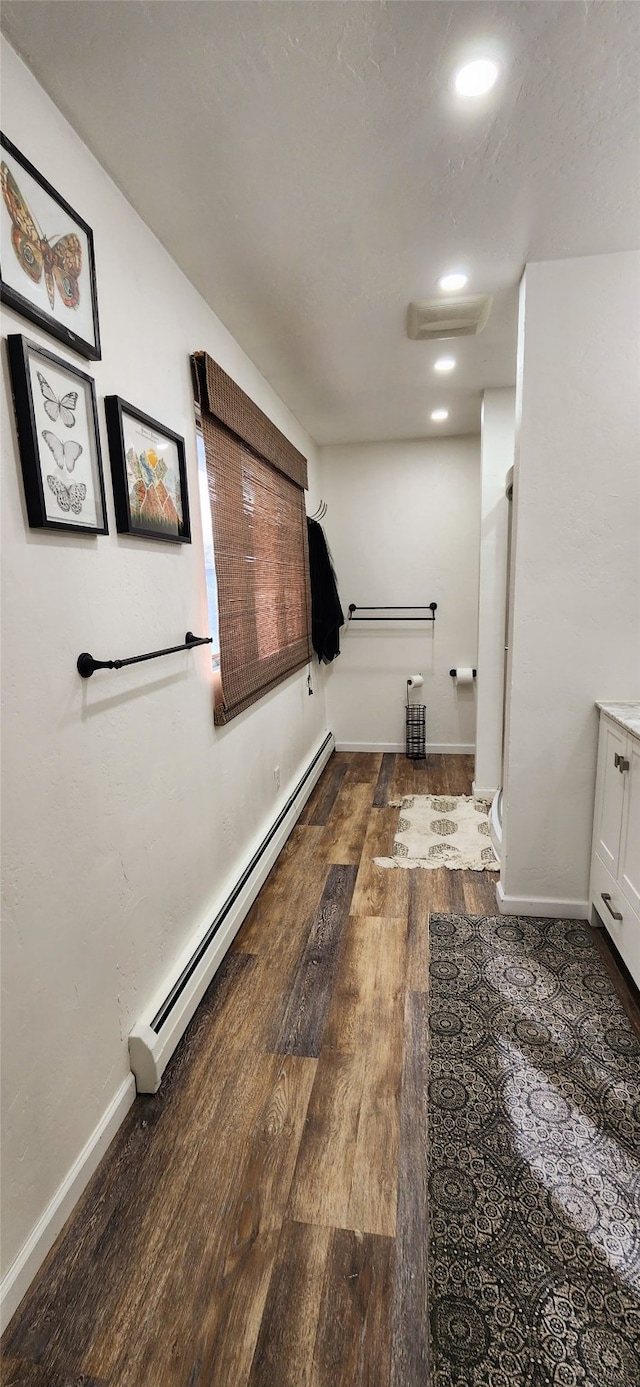 bathroom featuring a baseboard radiator, hardwood / wood-style flooring, and vanity