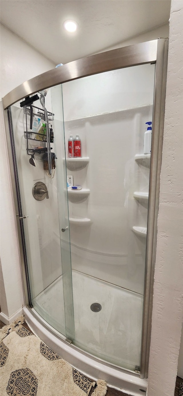 bathroom with a shower with shower door