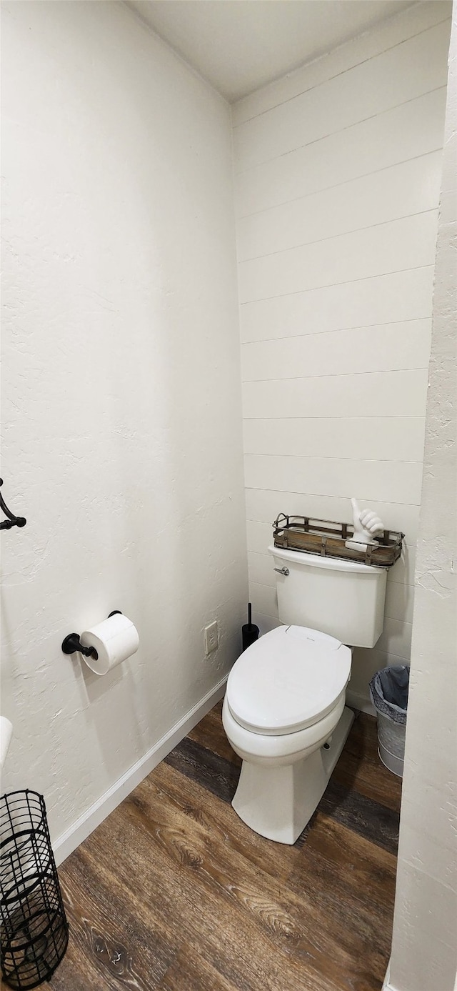 bathroom featuring wood-type flooring and toilet