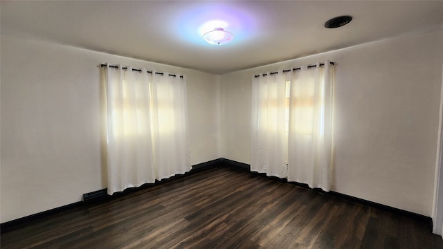 empty room with dark hardwood / wood-style flooring