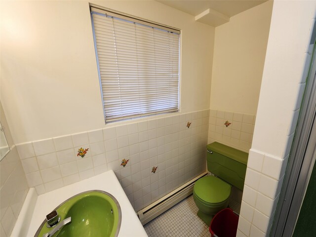 bathroom with tile walls, tile patterned flooring, sink, a baseboard radiator, and toilet