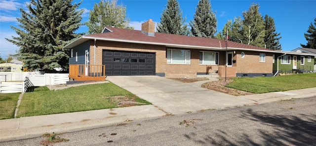 ranch-style home featuring a front lawn and a garage