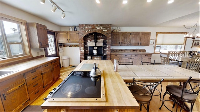 3653 Sophie Lake Rd, Eureka, MT 59917 - kitchen with tile countertops, healthy amount of natural light, light wood finished floors, and cooktop