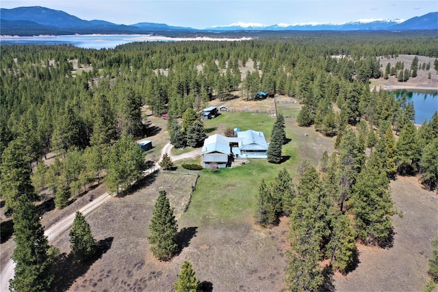 3653 Sophie Lake Rd, Eureka, MT 59917 - drone / aerial view of a heavily wooded area and a water and mountain view
