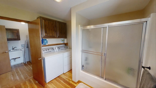 3653 Sophie Lake Rd, Eureka, MT 59917 - full bathroom featuring independent washer and dryer, wood finished floors, and enclosed tub / shower combo
