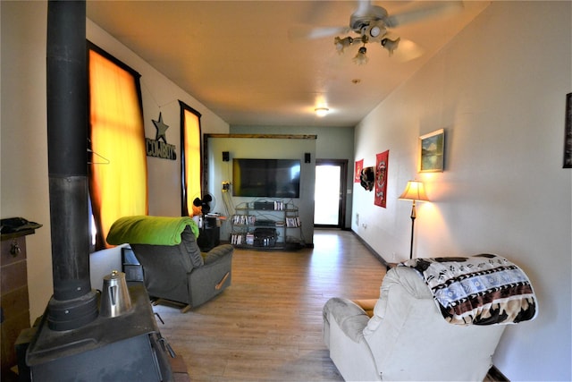 3653 Sophie Lake Rd, Eureka, MT 59917 - living area featuring light wood finished floors, ceiling fan, and a wood stove