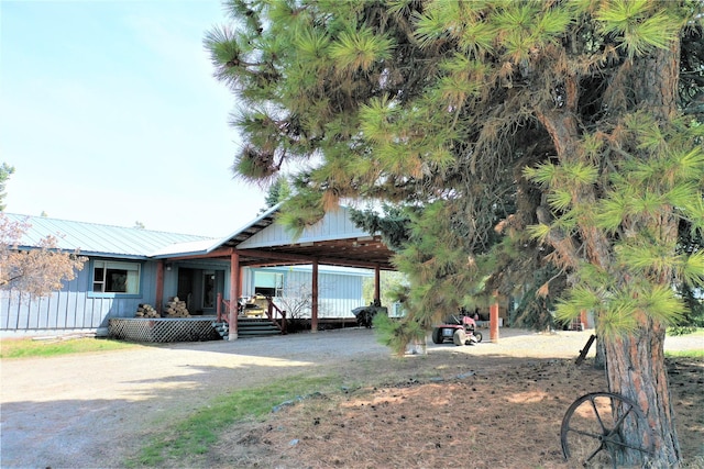 3653 Sophie Lake Rd, Eureka, MT 59917 - view of front facade with a metal roof, an attached carport, and board and batten siding