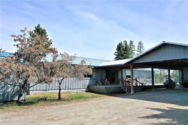 3653 Sophie Lake Rd, Eureka, MT 59917 - view of side of home featuring a metal roof and covered porch