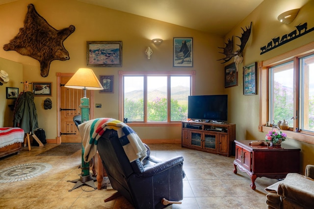 living room with lofted ceiling, plenty of natural light, baseboards, and light tile patterned floors