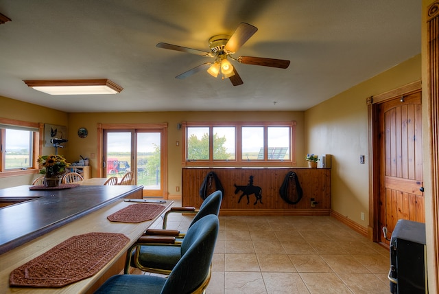 tiled dining space featuring ceiling fan