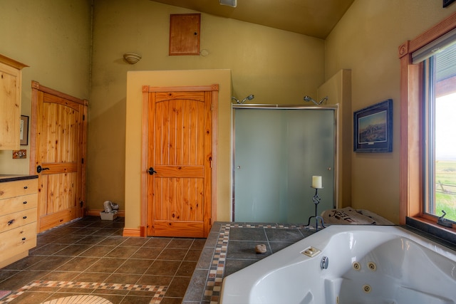 bathroom with high vaulted ceiling, walk in shower, and tile floors