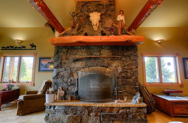 interior details featuring beamed ceiling, tile floors, and a fireplace